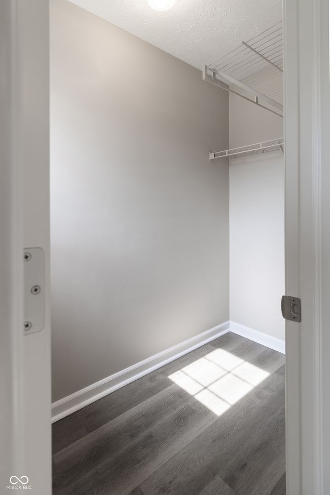 walk in closet featuring dark wood-style floors | Image 23