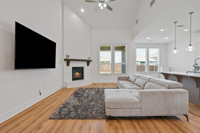 Large living area with floor to ceiling fireplace | Image 5