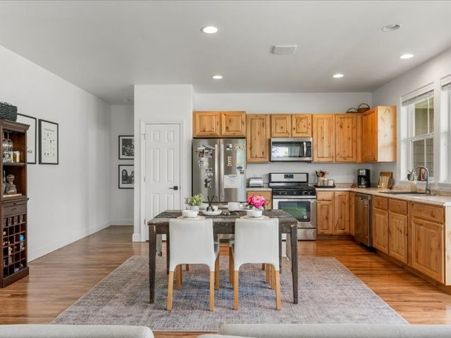 Kitchen featuring stainless steel appliances, light wood-type flooring, light countertops, and recessed lighting | Image 16