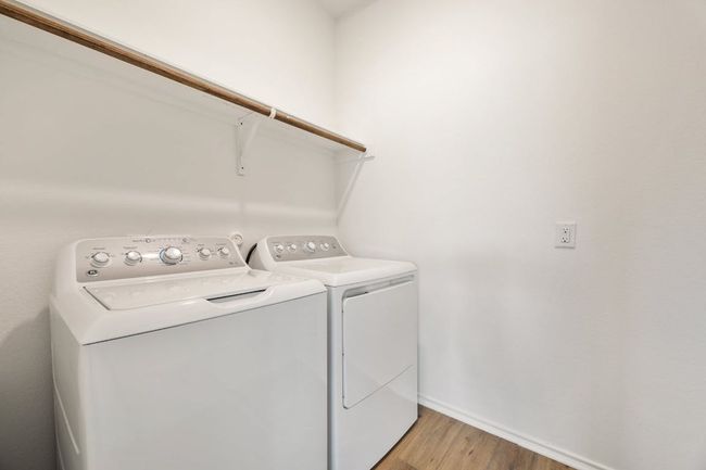 Laundry area with independent washer and dryer and light wood finished floors | Image 32