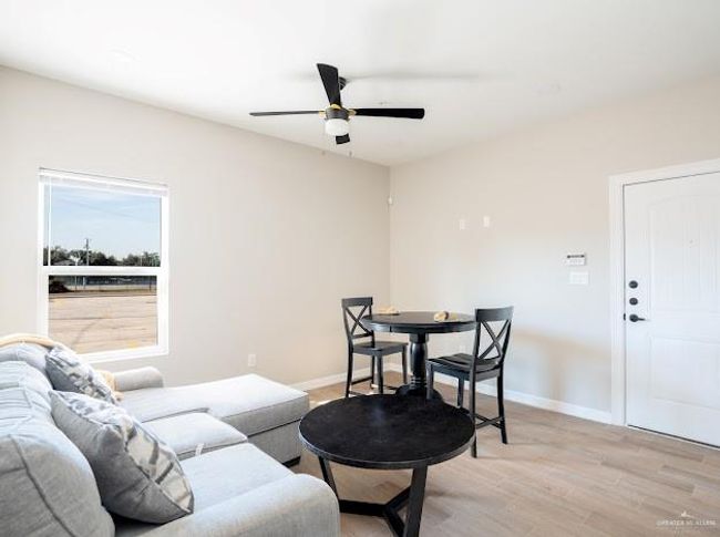 Living room with ceiling fan and light hardwood / wood-style flooring | Image 11