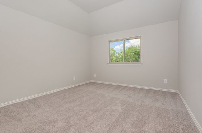 Unfurnished room with light colored carpet, baseboards, and lofted ceiling | Image 27