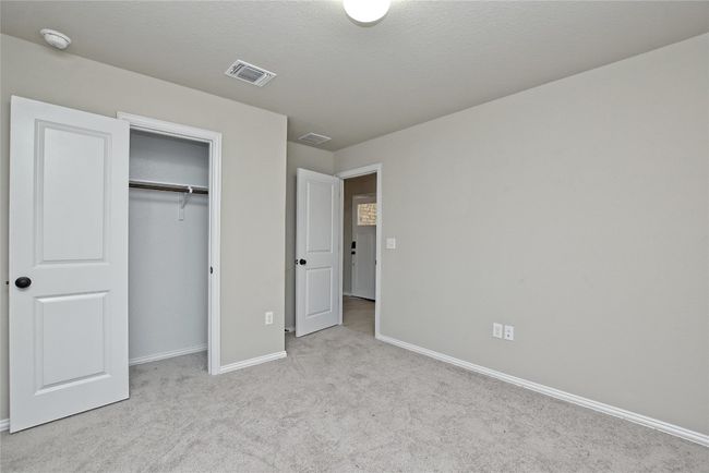 Unfurnished bedroom with a closet, visible vents, carpet flooring, and baseboards | Image 21