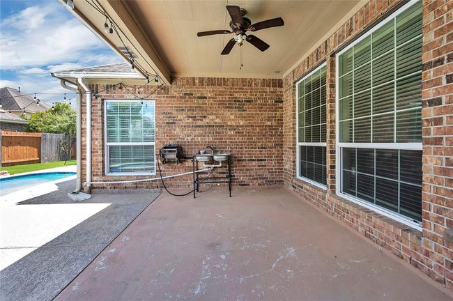Spacious covered patio with convenient utility sink. | Image 41