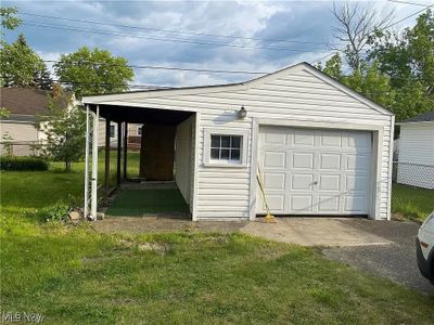 Garage with a lawn and a carport | Image 2