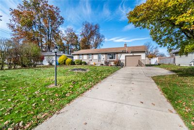 Single story home featuring a garage and a front yard | Image 3