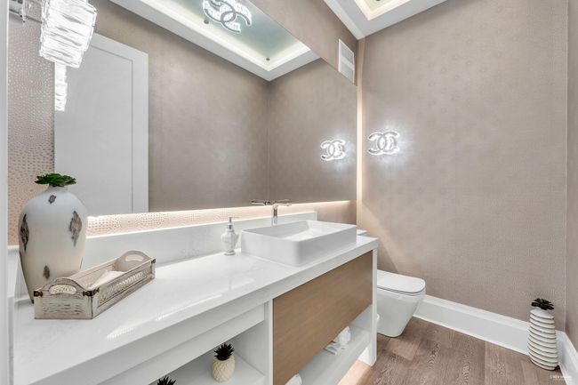 Bathroom featuring toilet, visible vents, baseboards, wood finished floors, and vanity | Image 13