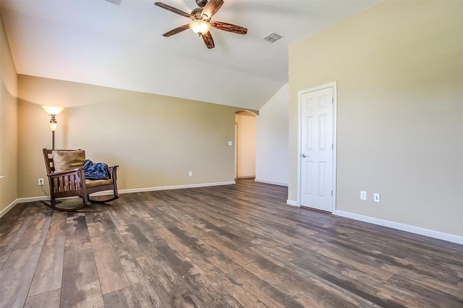 Large upstairs Game room featuring a ceiling fan & closet for storage. | Image 25