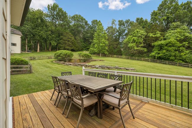 Spacious back deck just off the kitchen—perfect for grilling, dining, and entertaining with a view. | Image 22