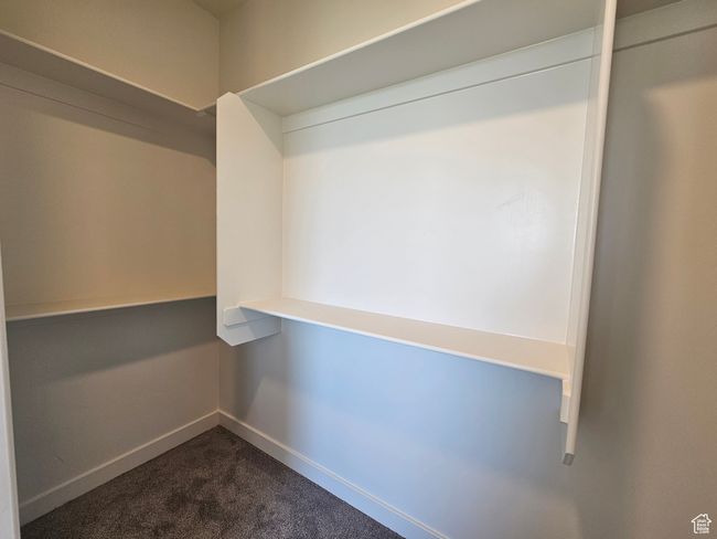 Spacious closet with dark colored carpet | Image 20