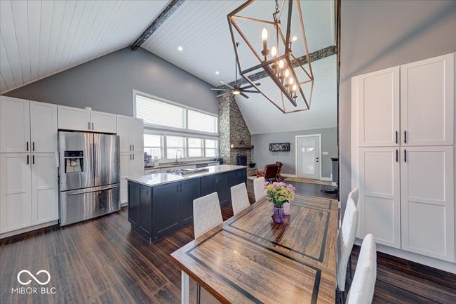 dining space with an inviting chandelier and a built in pantry | Image 20