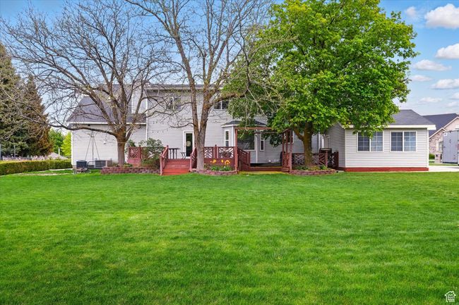 View of grassy yard with a deck | Image 11