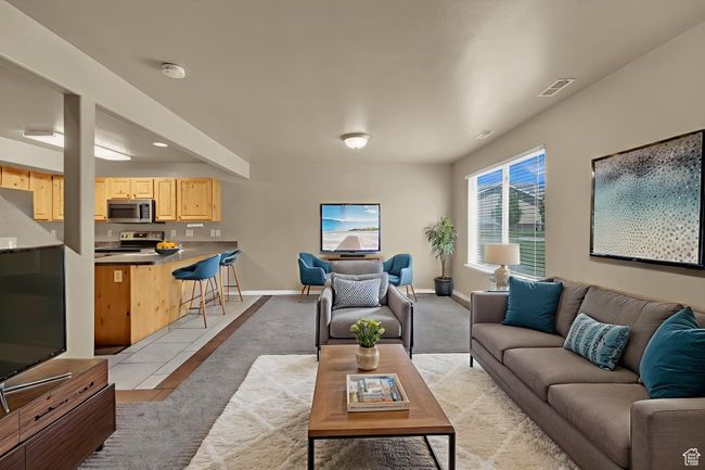 Living area featuring light tile patterned floors and baseboards | Image 6
