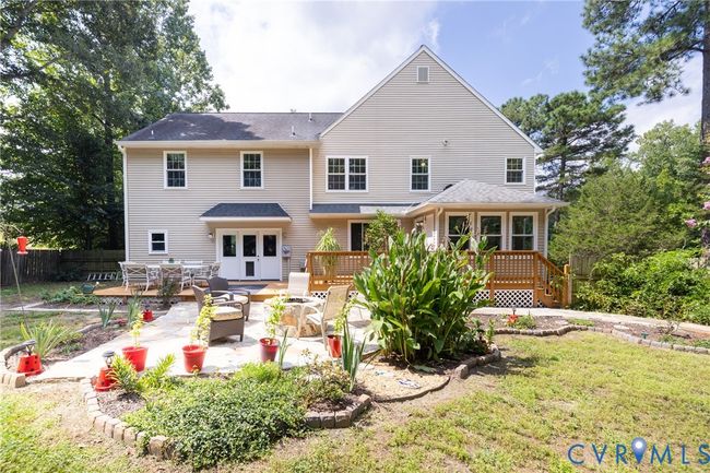 Back of house featuring an outdoor fire pit, a wooden deck, and a patio area | Image 45