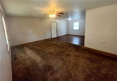 Living room with dark hardwood / wood-style floors and ceiling fan | Image 2