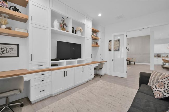 Custom built-in selves and cabinets with two desks and lighting. | Image 17