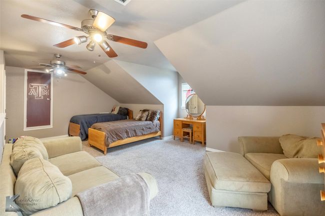 Bedroom featuring carpet, lofted ceiling, baseboards, and a ceiling fan | Image 26