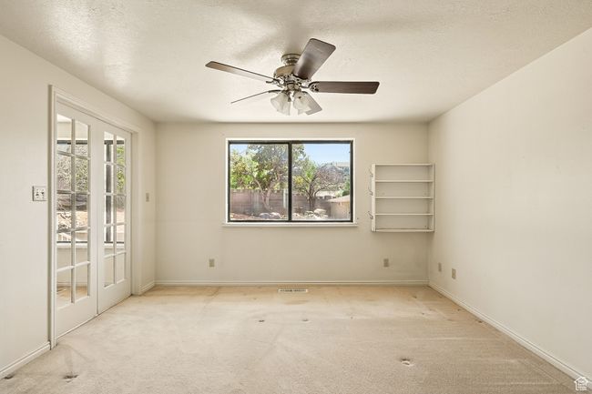 Unfurnished room with carpet flooring, a ceiling fan, and a textured ceiling | Image 18