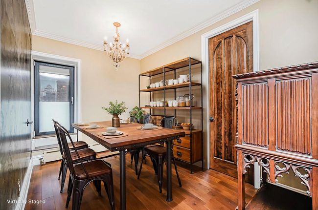 Dining space with a chandelier, wood-type flooring, and ornamental molding | Image 9