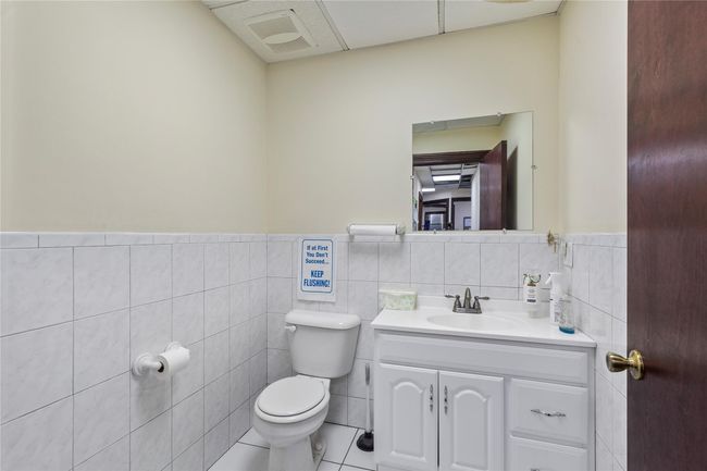 Bathroom featuring tile walls, vanity, tile patterned flooring, and toilet | Image 19