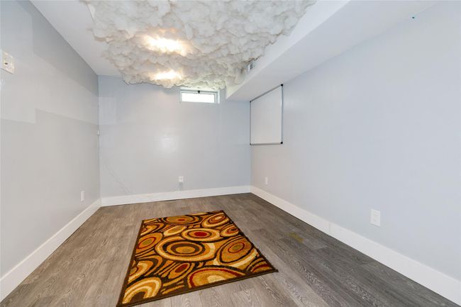 Below grade area featuring wood finished floors and baseboards | Image 25