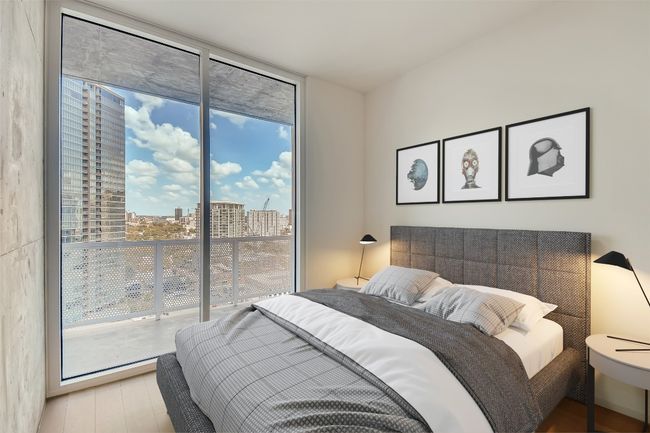 Bedroom with expansive windows, access to exterior, wood finished floors, and a view of city | Image 5