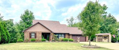 View of front of home featuring a garage and a front lawn | Image 1