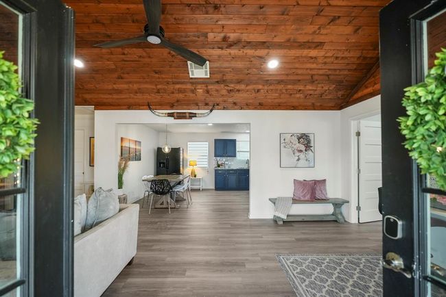 Step inside to an open-concept layout with raised wood ceilings and warm finishes—creating a space that feels both inviting and connected. | Image 7
