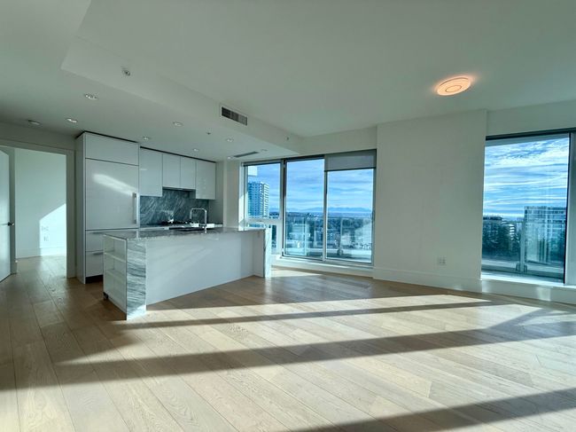 Kitchen featuring white cabinetry, modern cabinets, visible vents, light wood-style floors, and decorative backsplash | Image 4