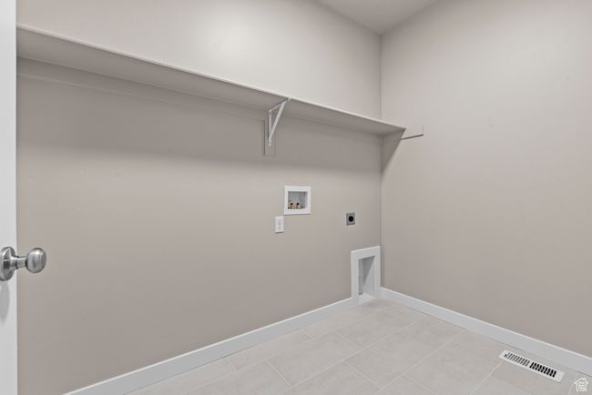 Washroom with hookup for a washing machine, hookup for an electric dryer, baseboards, and light tile patterned floors | Image 12