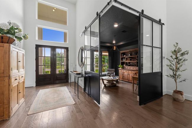 Impressive entry with high ceilings and corner iron doors for the study. | Image 9