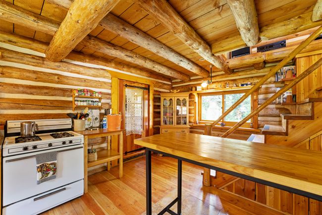 Propane stove and view to the storage room in the back of the cabin. | Image 20