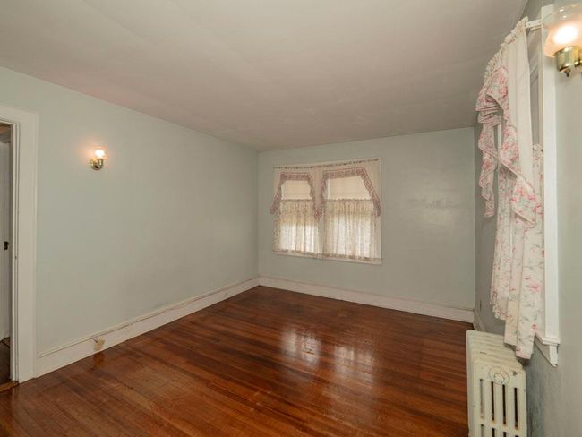 Unfurnished room with radiator heating unit and hardwood / wood-style floors | Image 24