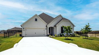 View of front facade featuring a garage and a front lawn | Image 1