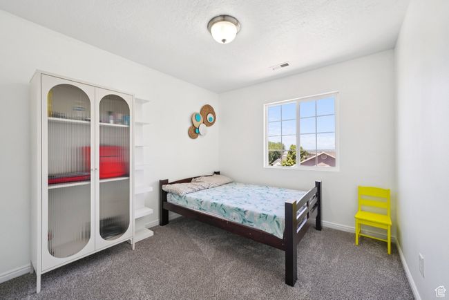 Carpeted bedroom with a textured ceiling and baseboards | Image 11