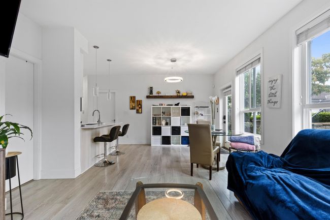 Living room with light wood-style flooring | Image 34