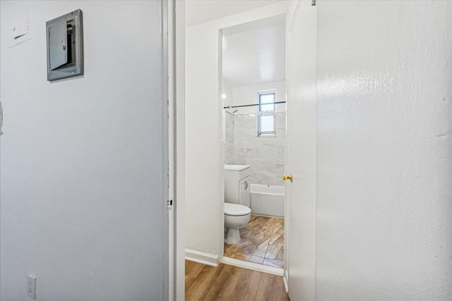 Bathroom with wood finished floors and bathing tub / shower combination | Image 9