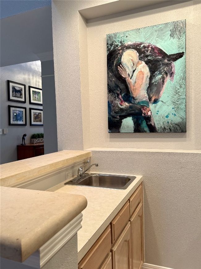 Bar featuring a sink and a textured wall | Image 18