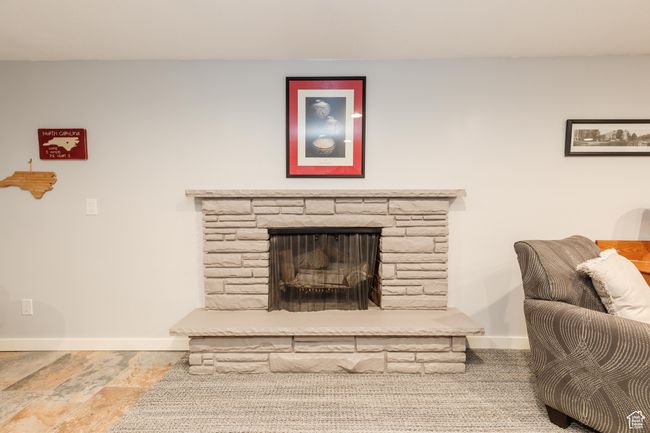 Living room with baseboards and a stone fireplace | Image 24