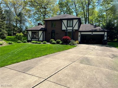 Tudor home with a garage and a front yard | Image 2