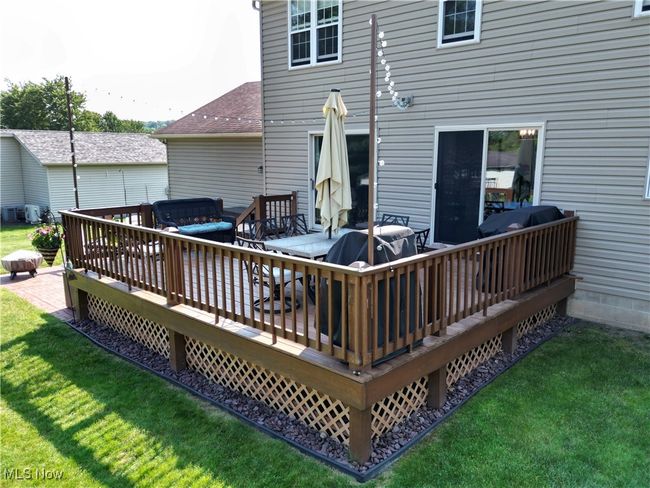 Wooden deck with a yard, area for grilling, and a hot tub | Image 10