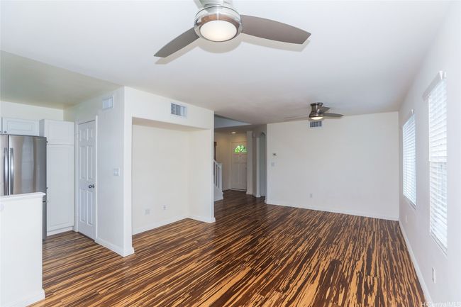 Combined living/dining room towards the front door and stairs. | Image 9