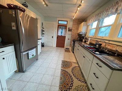 Kitchen featuring stainless steel appliances, track lighting, a paneled ceiling, and sink | Image 3