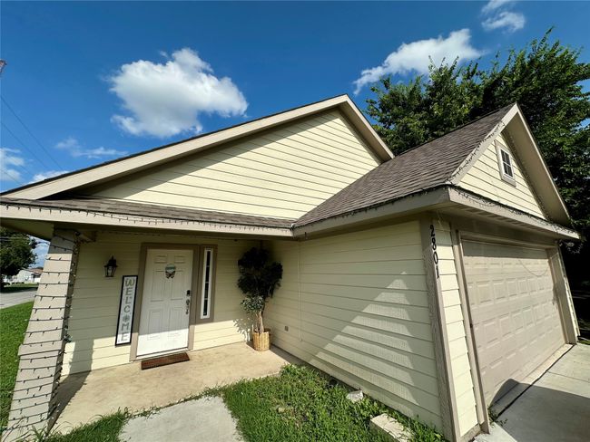View of front of home with roof with shingles and a garage | Image 6