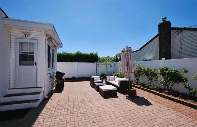 View of patio / terrace with entry steps, a fenced backyard, an outdoor living space, and area for grilling | Image 25