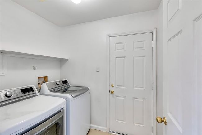Laundry area with washer and dryer and baseboards | Image 25
