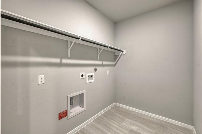 Laundry room with electrical outlets and gas hookups. Ready for washer and dryer installation. | Image 12