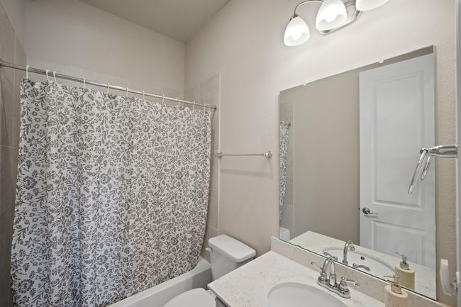 Third bathroom features atub/shower combo and vanitywith plenty of counter space. | Image 30