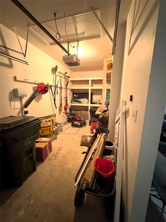Golf Cart side of the garage featuring a garage door opener. | Image 40