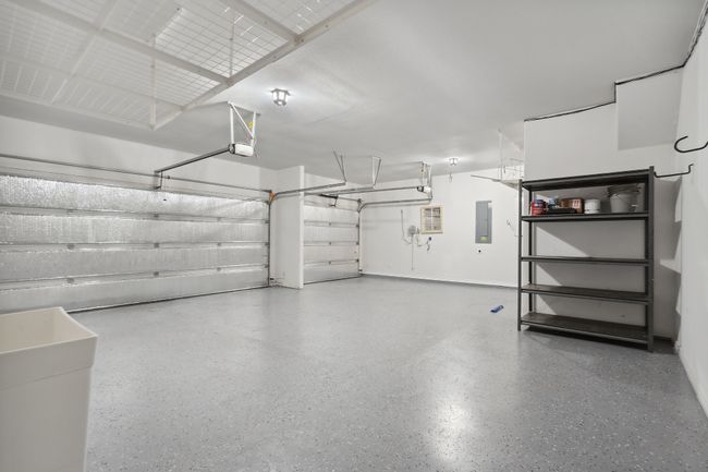 Garage with electric panel and baseboards | Image 26